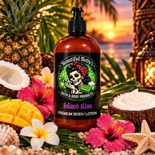A bottle of Beautiful Betty's Island Kiss Premium Body Lotion stands in a tropical beach-themed arrangement with pineapples, coconuts, flowers, starfish, and a sunset ocean background.